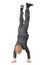 Boy wearing suit and sneakers doing handstand
