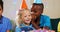 Boy whispering to girl while sitting with friends during birthday party 4k