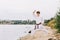 Boy in a white kimono with brown belt on a natural background. Intense karate exercise concept. Copy space.