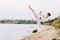 Boy in a white kimono with brown belt on a natural background. Intense karate exercise concept. Copy space.