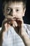 Boy in white playing wooden pipe