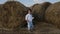 Boy in white shirt and t-shirt in blue pants dancing in the field