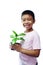 The boy who is holding a pot of seedlings