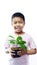 The boy who is holding a pot of seedlings