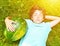 Boy with whole water melon lay on the green grass