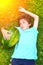 Boy with whole water melon lay on the green grass