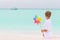 Boy with windmill on beach