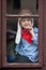 Boy on the window, laughing and drinking tea