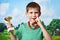 Boy winner with cup and medal on nature