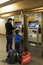 Boy and woman buyng tickets at Subway