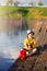 Boy on wooden dock with a fishing net