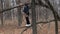 Boy in the woods riding on a broken tree