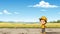 A boy in a yellow hat standing in a field. Generative AI image.