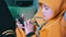 Boy in Yellow Hoody sits on Sofa, Looking Messages, Play on Smartphone at Home