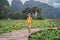 Boy in a yellow on the path among the lotus lake. Mua Cave, Ninh Binh, Vietnam. Vietnam reopens after quarantine