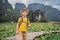 Boy in a yellow on the path among the lotus lake. Mua Cave, Ninh Binh, Vietnam. Vietnam reopens after quarantine