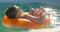 Boy in yellow sunglasses relaxed swimming in pool on inflatable ring