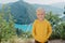 Boy young traveler on the background The famous Piva Canyon with its fantastic reservoir. View of road above