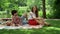 Boyfriend and girlfriend having picnic on blanket. Couple spending time together