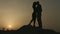 Boyfriend and girlfriend kissing, looking at sunset. Happy together forever