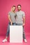 boyfriend and girlfriend posing with empty board, isolated