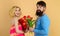 Boyfriend gives bouquet flowers to girlfriend. Love, relationship, dating, anniversary. Man congratulates woman with birthday.