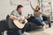 boyfriend playing guitar for happy girlfriend