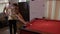 Boyfriend teaching his girlfriend to play pool flirting and having fun -