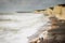 Boys on beach rough storm Desmond waves crashing beach