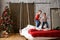 Boys, brothers, have fun. jumping on  hanging bed, in room with Christmas tree