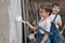 Boys with brushes and paint at an old wall