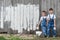 Boys with brushes and paint at an old wall