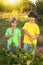 Boys with a carrot and in the garden, children harvest vegetable