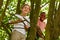 Boys climbing tree and laughing