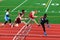 Boys competing in hurdles at a Track Competition