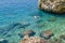 Boys dive with mask in crystal clear sea water in Brela, Croatia.