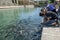 Boys feed the sacred fish at Balikli Gol.