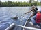 Boys fishing in a canoe catch a walleye