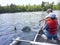 Boys fishing in a canoe catch a walleye