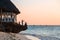 Boys fishing at sunset on the rock on the ocean, Nungwi, Kendwa, Zanzibar island, Tanzania