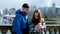 boys girl stand Pacific Ocean with ships take a selfie look diligently into the phone skyscrapers bridge blue color in