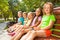 Boys and girls sitting on the bench in park