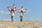 Boys with grandparents sitting on sand