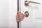 Boys hand sticking out of closed door. Prevent child hazard concept. School kid playing hide and seek game at home or at