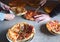 Boys hands cutting pizza