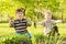 Boys hold up radishes in garden