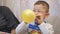 Boys inflate balloons, emotions fear closeup,in profile