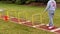 Boys jumping over yellow hurdles on a track long jump runway