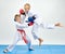 Boys in karategi are training punch in jump