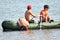 Boys kayaking and diving on sunny day